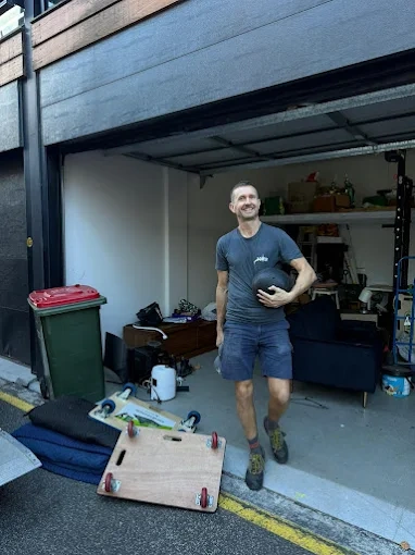 Andy with moving dollies and blankets outside a garage